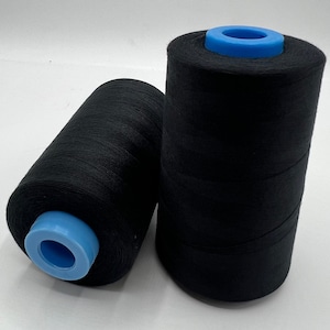 May include: Two black thread spools with blue plastic cores. One is upright, the other on its side. The thread is tightly wound. The spools are set against a white background. Suitable for sewing and craft projects.