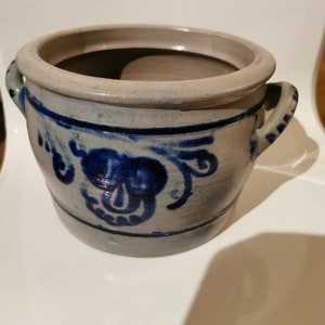 May include: A set of three ceramic mugs with a speckled, matte finish. The mugs are in shades of cream, light gray, and dark gray. Each mug has a simple, minimalist design, perfect for coffee or tea.