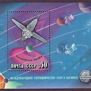 May include: A vintage Soviet Union postage stamp featuring a spacecraft in orbit around a planet. The stamp is blue and purple with a red and white sun in the lower left corner. The text on the stamp reads "ПОЧТА СССР К 50" and "МЕЖДУНАРОДНОЕ СОТРУДНИЧЕСТВО СССР В КОСМОСЕ ИНТЕРКОСМОС".