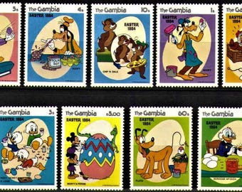May include: A sheet of postage stamps from The Gambia, featuring Disney characters celebrating Easter in 1984. The stamps showcase Donald Duck, Goofy, Mickey Mouse, Chip 'n' Dale, and Pluto, with colorful backgrounds and Easter-themed imagery.