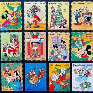 May include: A set of nine colorful stamps featuring various Disney characters celebrating Christmas. The stamps are from Sierra Leone and feature Mickey Mouse, Minnie Mouse, Goofy, Donald Duck, and others.