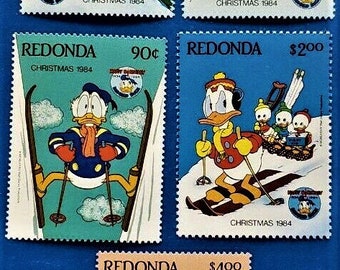 May include: A collection of five Redonda Christmas 1984 postage stamps featuring Disney characters. The stamps depict Mickey Mouse, Donald Duck, and nephews engaging in winter sports like sledding and skiing, with prices ranging from 45¢ to $4.00.