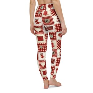 May include: Leggings featuring a patchwork design of red and white buffalo plaid squares interspersed with cream-coloured squares. The pattern includes illustrations of buttons, Christmas trees, stockings, hearts, and gift boxes throughout.