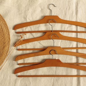 Four vintage wooden hangers