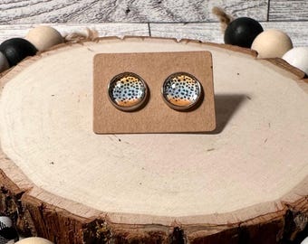 May include: A pair of stud earrings with a brown, orange, and blue speckled pattern.