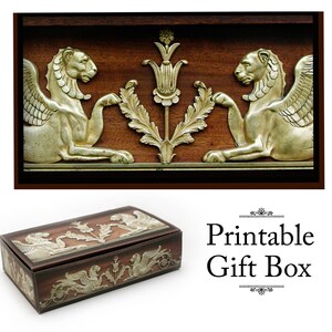 May include: Printable gift box with a decorative design featuring two winged lions and a stylized flower. The box is made of brown cardboard and has a gold-colored design.