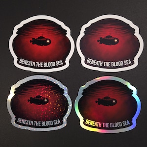 May include: Four stickers with a design of a submarine in a red underwater scene. The text "BENEATH THE BLOOD SEA" is printed at the bottom of each sticker. Two stickers have a holographic finish.