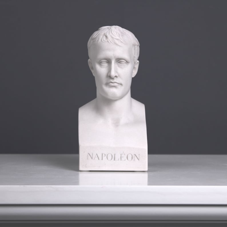 May include: White plaster bust of Napoleon Bonaparte, with the name "NAPOL&Eacute;ON" inscribed on the base.