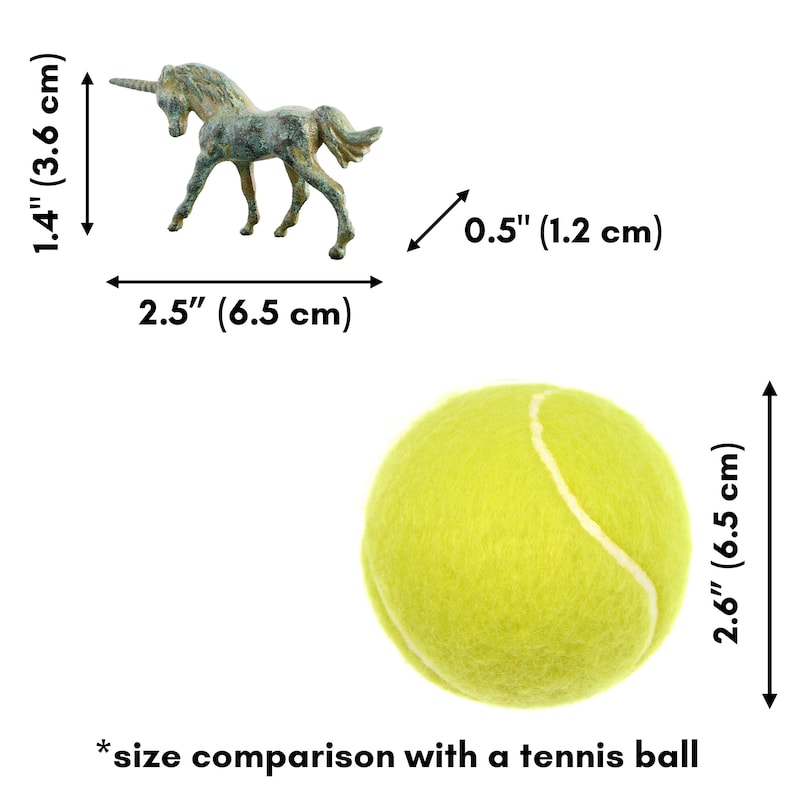 May include: A bronze unicorn figurine, approximately 3.6 cm tall and 6.5 cm long, next to a yellow tennis ball for size comparison. The unicorn is standing on all four legs with its head tilted slightly to the side. The tennis ball is 6.5 cm in diameter.