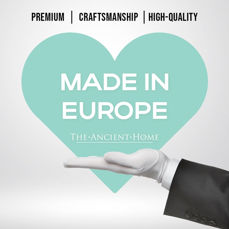 May include: A white gloved hand holding a teal heart with the text "MADE IN EUROPE" and the words "THE ANCIENT HOME" below.