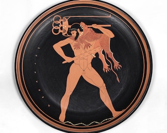 May include: A black and red Greek pottery plate with a depiction of a man holding a club and a lion. The inscription on the plate reads "HEPAKLES".