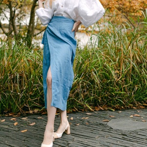 Stylish and elegant woman in an autumn garden posing in an organic linen wrap pencil skirt with pockets, Long high waisted skirt for natural and trendy look of a modern confident woman.