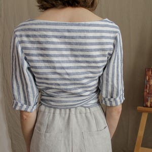 Back of the linen wrap top showing soft structure and relaxed silhouette. Crafted from breathable organic fabric, this summer blouse combines comfort with an elegant, natural look.