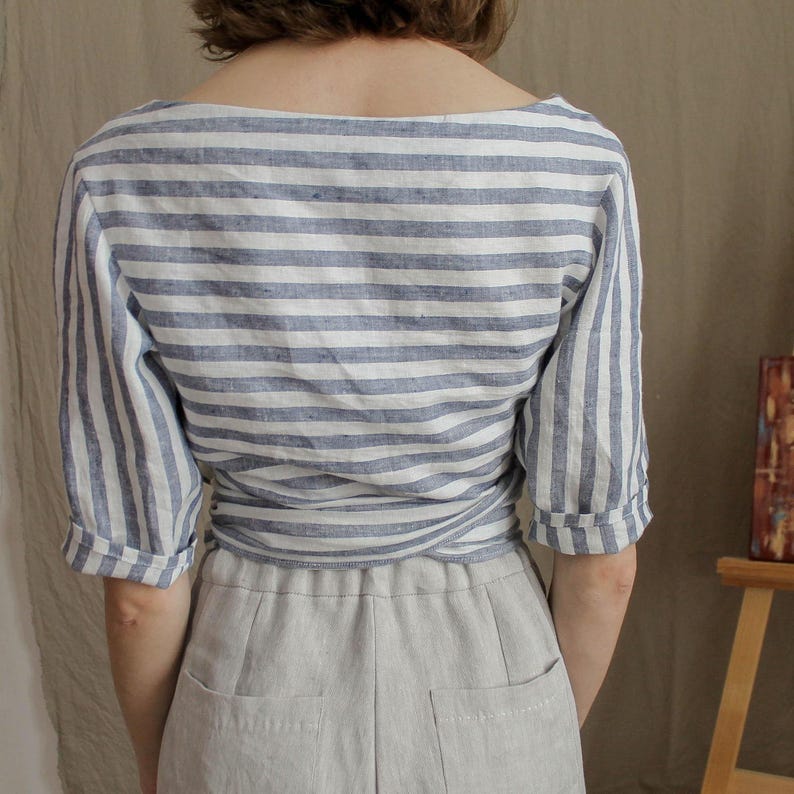Back of the linen wrap top showing soft structure and relaxed silhouette. Crafted from breathable organic fabric, this summer blouse combines comfort with an elegant, natural look.
