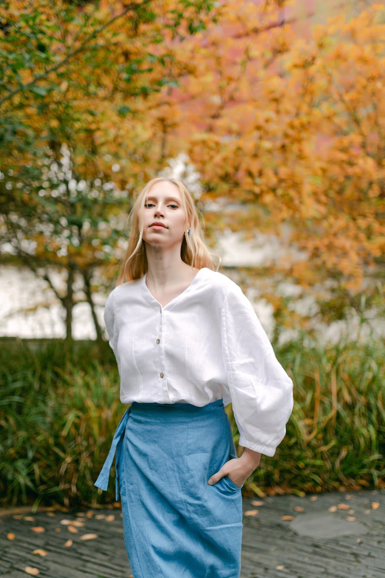 Stylish and elegant woman in an autumn garden posing in an organic linen wrap pencil skirt with pockets, Long high waisted skirt for natural and trendy look of a modern confident woman.