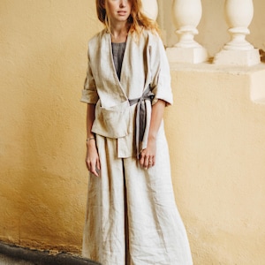Natural linen culottes styled with a matching linen kimono jacket for a modern minimalist look. Wide leg fit, high waist with adjustable elastic back, deep pockets, and soft pleats for comfort and movement. Perfect for coastal grandma style, boho outfits, or summer resort wear. Lightweight, breathable, and plus size friendly. Ready to ship in 24 hours from USA with fast delivery across the US.