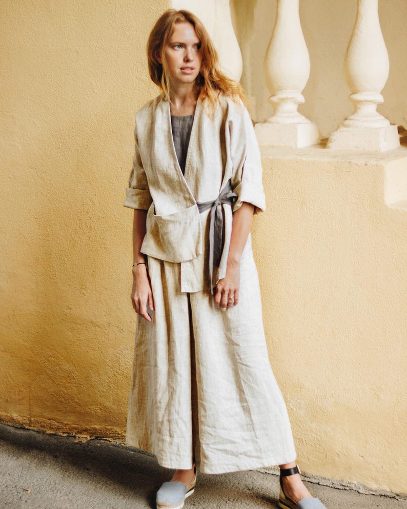 Natural linen culottes styled with a matching linen kimono jacket for a modern minimalist look. Wide leg fit, high waist with adjustable elastic back, deep pockets, and soft pleats for comfort and movement. Perfect for coastal grandma style, boho outfits, or summer resort wear. Lightweight, breathable, and plus size friendly. Ready to ship in 24 hours from USA with fast delivery across the US.