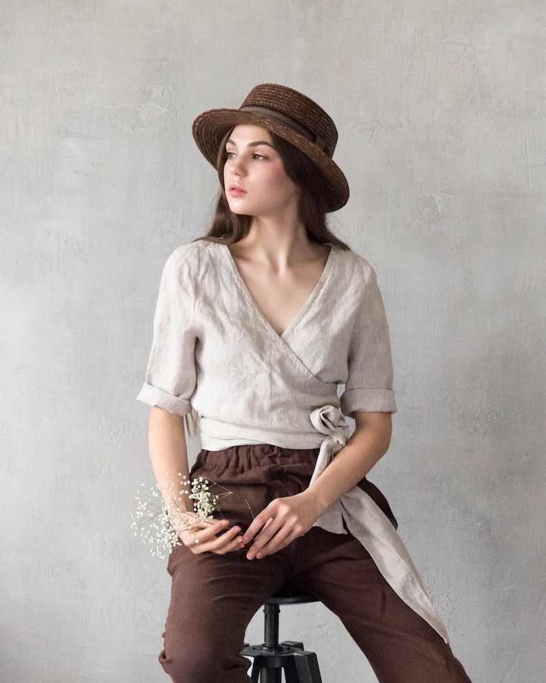 Linen wrap blouse for women made from softened natural linen, featuring a flattering V-neckline, tie waist, and minimalist design. Perfect for a European vacation, city travel, or a relaxed capsule wardrobe. Ships quickly from the USA, dispatched within 1 day.