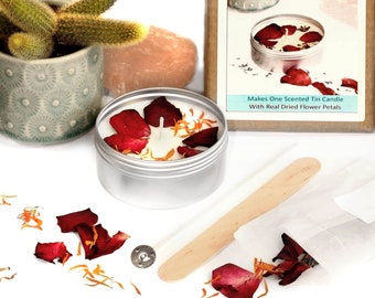 May include: Candle making kit with a white tin candle with dried rose petals, a wooden stirring stick, and a small bag of dried petals. The box says "Candle Making Kit" and "Makes One Scented Tin Candle With Real Dried Flower Petals".