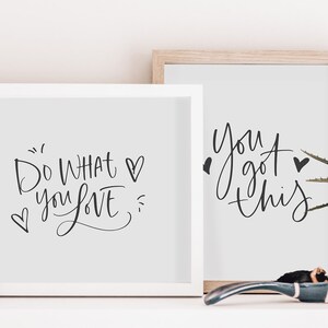 May include: Two framed prints with motivational quotes. The left print says "Do what you love" with a heart symbol. The right print says "You got this" with a heart symbol.