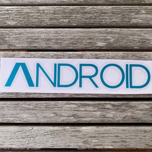 May include: A white sticker with the word "ANDROID" in teal blue lettering.