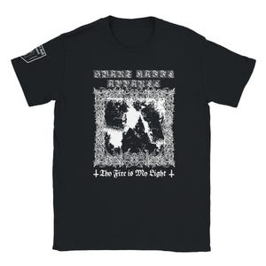 May include: A black short-sleeved t-shirt featuring a white graphic print on the chest. The design includes the text Svart Kaffi Apparel above a central image of a building framed by intricate, thorny patterns, with the text Thy Fire is My Light below.