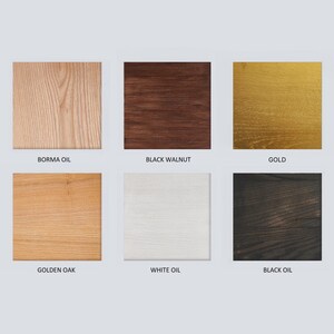 Puede incluir: Una colecci&oacute;n de seis muestras de madera cuadradas que muestran diferentes acabados. Los acabados incluyen Borma Oil, Black Walnut, Gold, Golden Oak, White Oil y Black Oil. Cada muestra tiene el nombre del acabado impreso debajo.