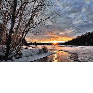 May include: A scenic winter sunset over a frozen river with snow-covered banks and trees in the background.