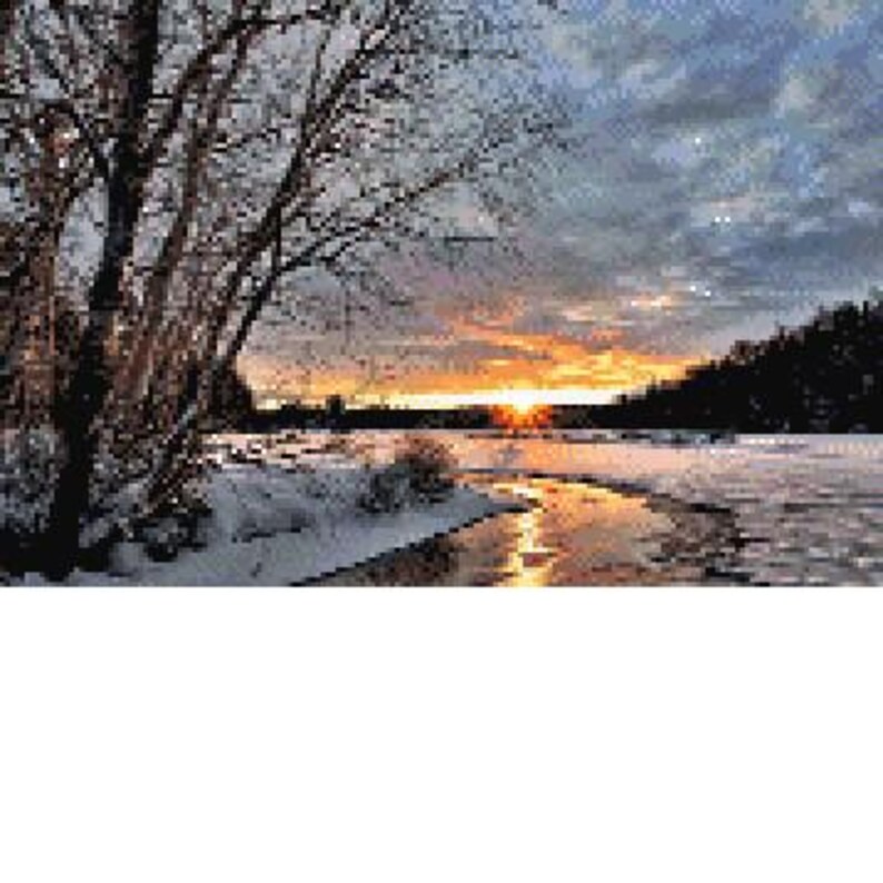 May include: A scenic winter sunset over a frozen river with snow-covered banks and trees in the background.