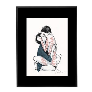 May include: A framed art print featuring a black ink illustration of two figures embracing. One figure wears a dark blue shirt, while the other displays red fern-like patterns on their skin. The artist signature Cherwan T. is visible in the corner.