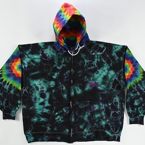 May include: A black zip-up hoodie with tie-dye patterns in shades of green, blue, and purple. The hood is lined with a rainbow tie-dye pattern.