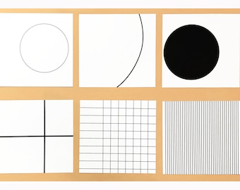 May include: A collection of six white square cards with black geometric designs. The designs include a circle, a curved line, a solid circle, intersecting lines, a grid, and vertical lines. The cards are arranged on a light brown background.