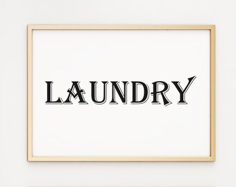 May include: A gold framed print with the word "LAUNDRY" in a black, stylised font.