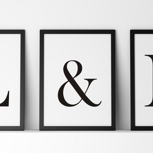 May include: Three black framed prints with white backgrounds. The prints feature the letters "L", "&", and "E" in a bold, black font.