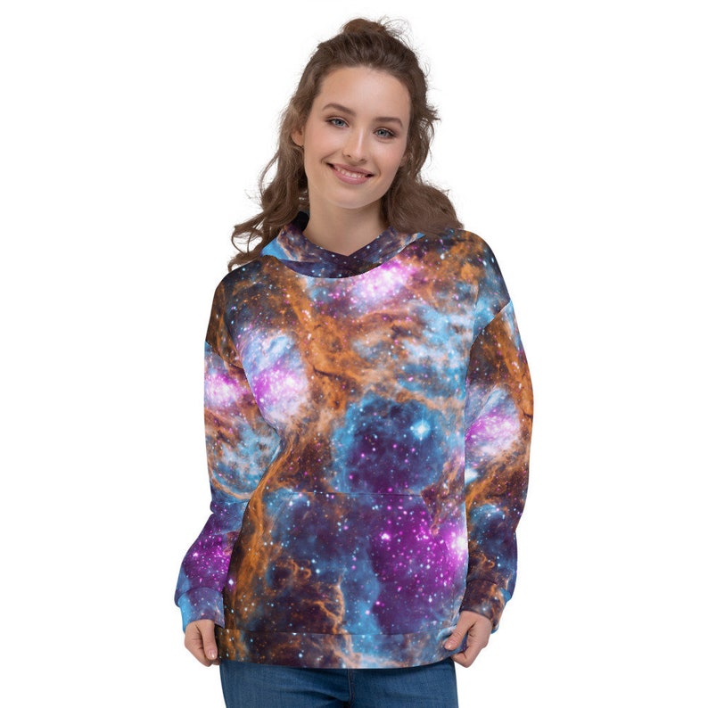May include: A hooded sweatshirt featuring a vibrant galaxy design in shades of blue, purple, and orange. The pullover has a front pocket and a drawstring hood. The all-over print creates a cosmic and eye-catching look.