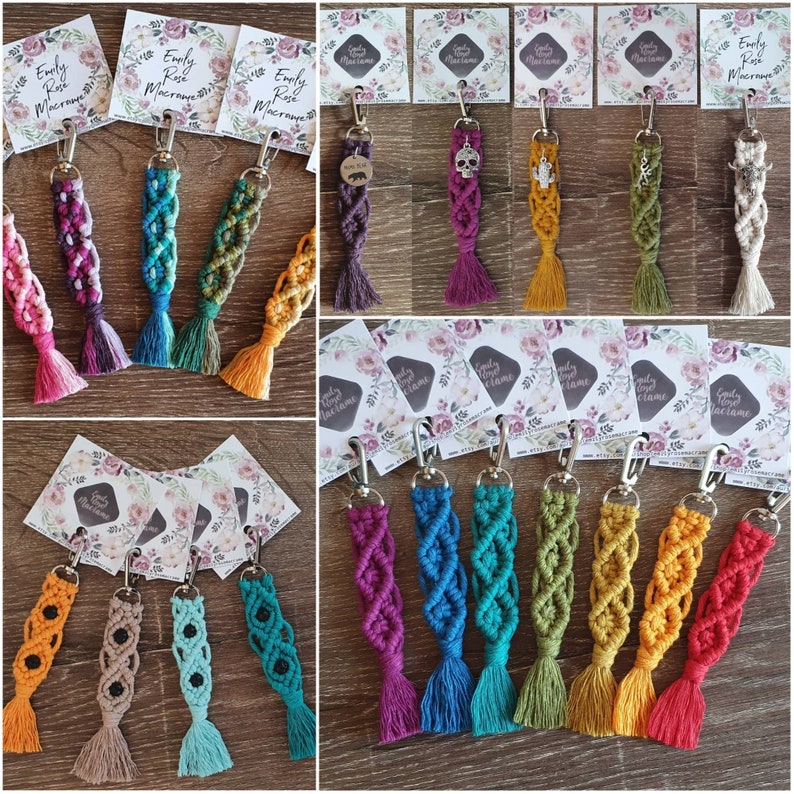 May include: Assortment of colorful macrame keychains with various charms. The keychains are made with a variety of colors, including pink, blue, green, purple, and yellow. Each keychain has a small charm attached to the end, such as a skull, a bear, or a flower.