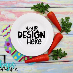 May include: A white plate with the text "YOUR DESIGN HERE" on a colorful wooden background.  The plate is surrounded by carrots and green parsley.  There are also colorful paper Easter eggs around the plate.  The text "CRAFT MOCKUPS BY HOOPMAMA" is at the bottom of the image.