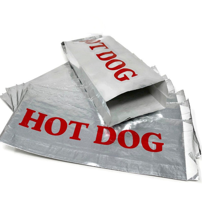 May include: A stack of silver foil hot dog bags with red "HOT DOG" printed on the front.