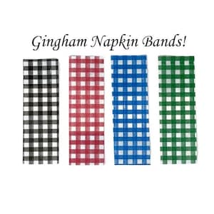 May include: Four gingham napkin bands in black and white, red and white, blue and white, and green and white.