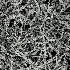 May include: A close-up of a pile of gray shredded paper, commonly used as packing material for fragile items.