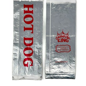 May include: Two silver foil hot dog bags. The bag on the left has "HOT DOG" printed in red. The bag on the right has "CARNIVAL KING" printed in red with a crown above the text. The bag on the right also has "Do Not Microwave" printed in black.