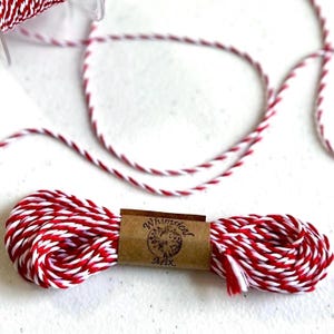 May include: A roll of red and white baker's twine with a brown label that reads "Whimsical Mix".