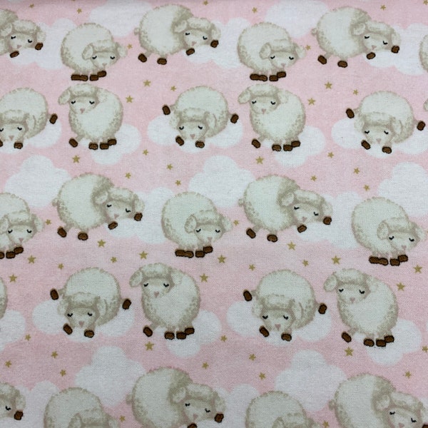 554 Flannel fabric pink with fluffy sheep on clouds and gold stars in a row sold by the yard.