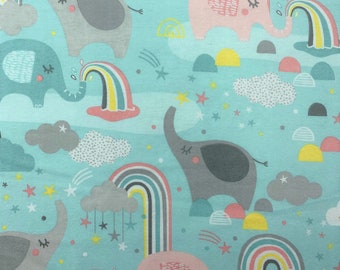 870 Flannel fabric aqua background with elephants rainbows clouds & stars sold by the yard.