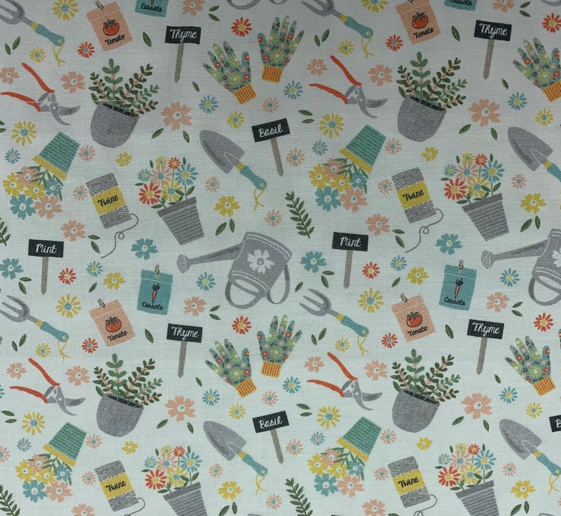 328 COTTON fabric white background with tossed garden tools watering cans flowers pots seed packets & gloves sold by the yard. image 1