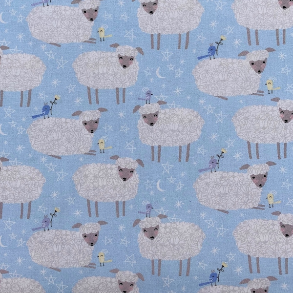 511 COTTON fabric blue background with white sheep birds & stars sold by the yard.