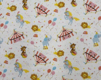 1391 Flannel fabric white with tossed circus tents animals balloons sold by the yard.