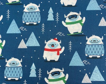 264 COTTON fabric blue background with snow Yeti and hats scarves sweaters trees and snow drops sold by the yard.