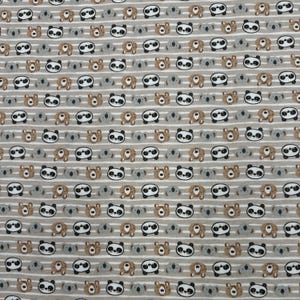 1245 Flannel fabric with tan stripes with brown black & gray bear faces sold by the yard.