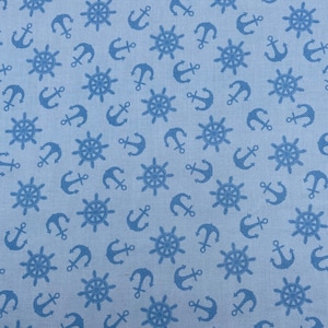 610 COTTON fabric light blue background with dark blue tossed anchors & ship steering wheels sold by the yard.